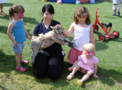 Children at Chatham nursery meeting a lamb on their Farmyard Fun Open Day