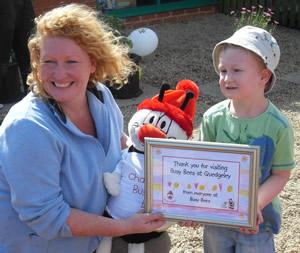 Children from Quedgeley Nursery present Charlie with a thank you certificate and a Busy Bee