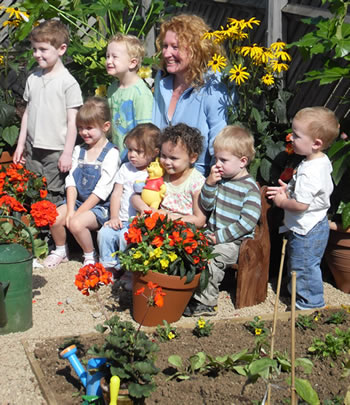 Charlie Dimmock and the Children from Busy Bees Childrens Nursery in Quedgeley Celebrating their winning garden design in a competition run by Disney.