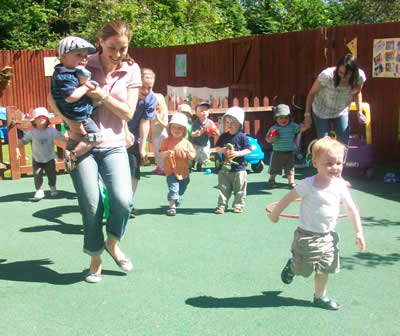 Children and parents having fun on a sunny sports day at Rothamsted nursery in Harpenden