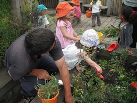 Children working in their nursery garden as part of the Change4Life initiative
