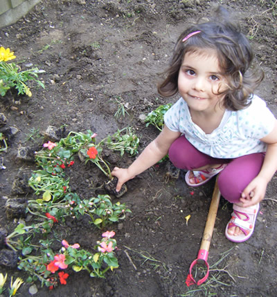 A little girl enjoying the garden at her Busy Bees childrens nursery