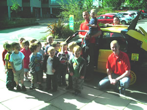 Children at Guiseley Nursery surrounding the bee car driven by their charity fundraising heroes from the Police Force. 