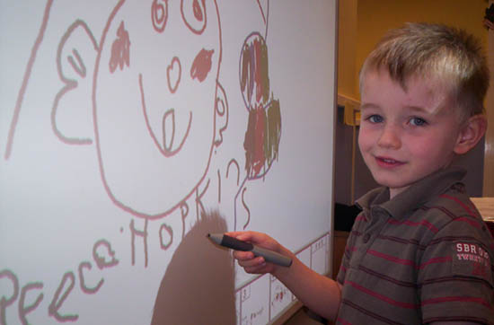 boy drawing on whiteboard
