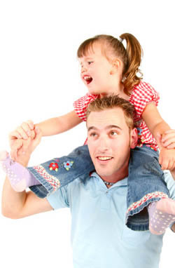 Little girl sitting on a mans shoulders