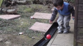 Pre-School children had fun playing with construction toys outside in the garden, children used plastic balls to roll on the water pipes, they all took turns and enjoyed playing.