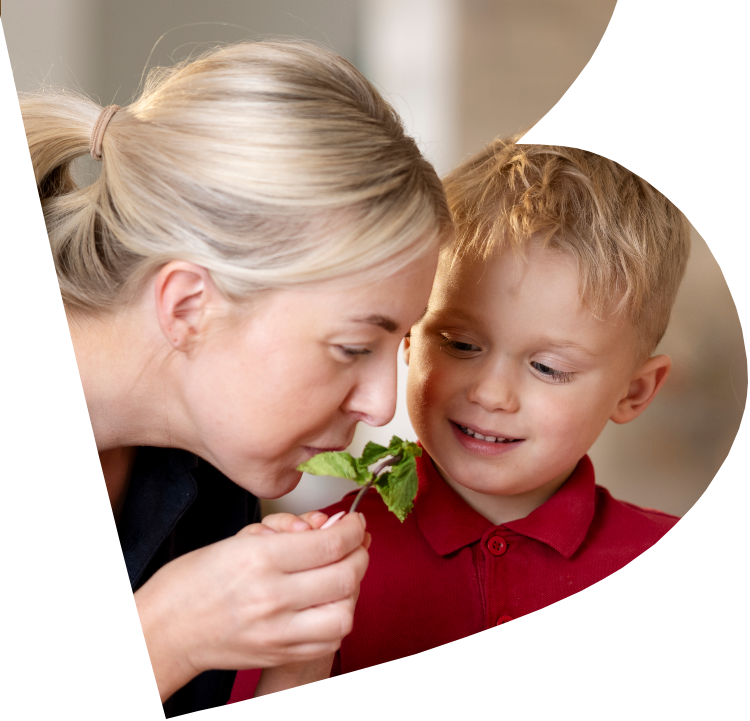 Child and carer with a small plant