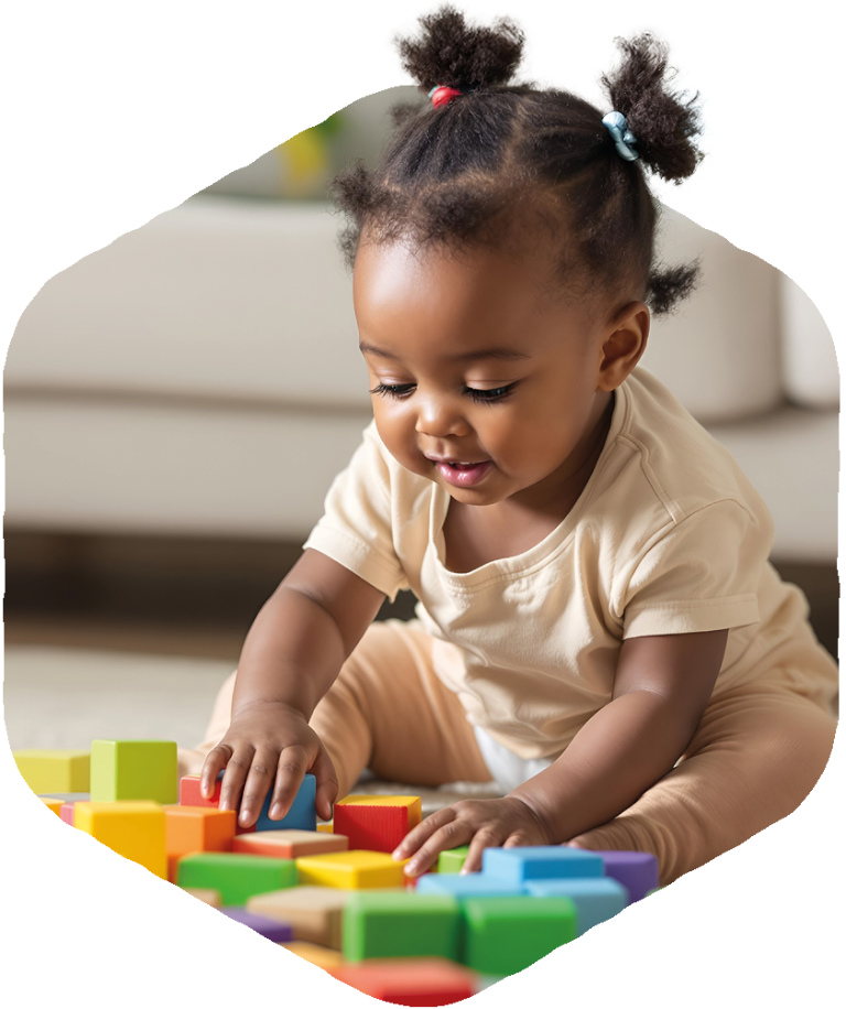 Little girl plays with bright coloured wooden building blocks