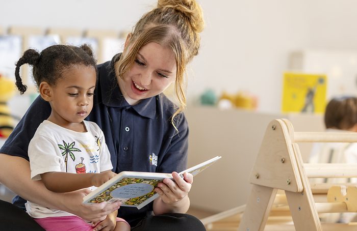 A practitioner sharing a picture book with a young child.